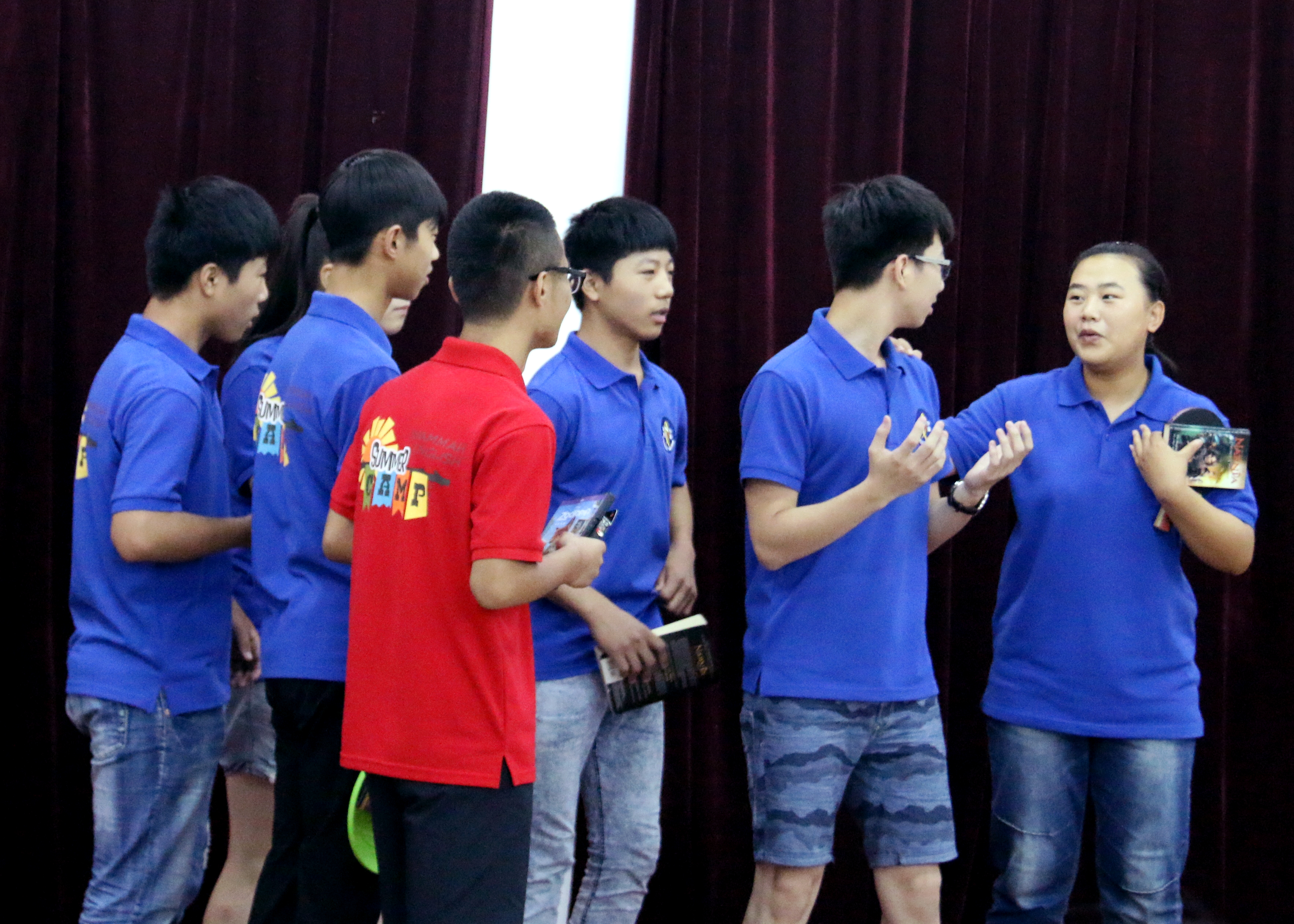 Young adults doing a skit at camp.